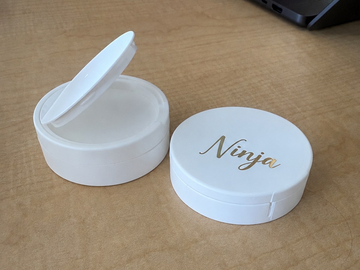 White pouch can with a gold logo printed directly on the lid