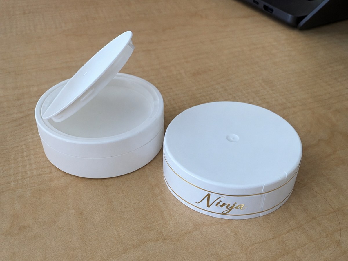 White pouch can with an applied sidewall wrap label in gold